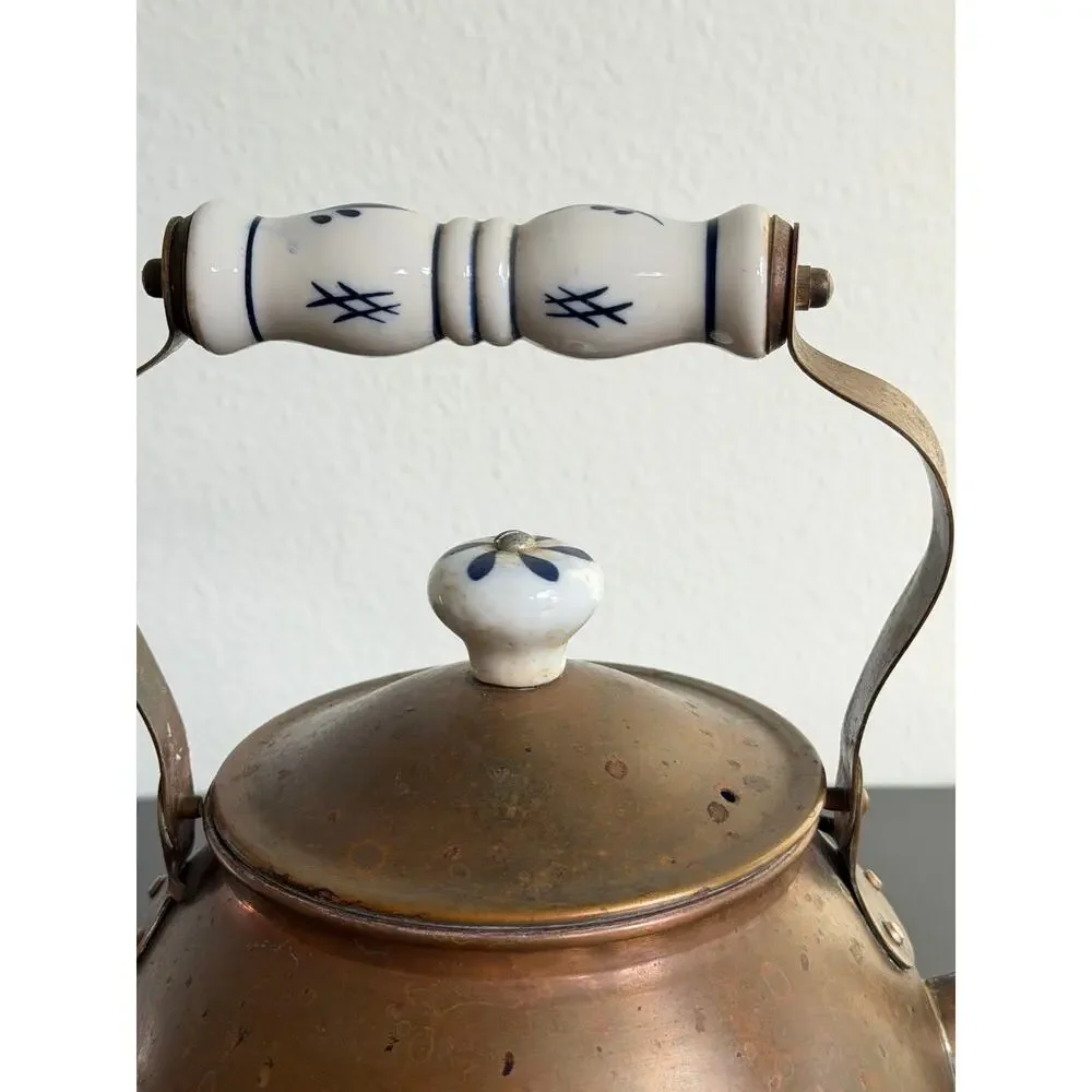 Vintage copper tea kettle with hand-painted blue and white porcelain handle lid